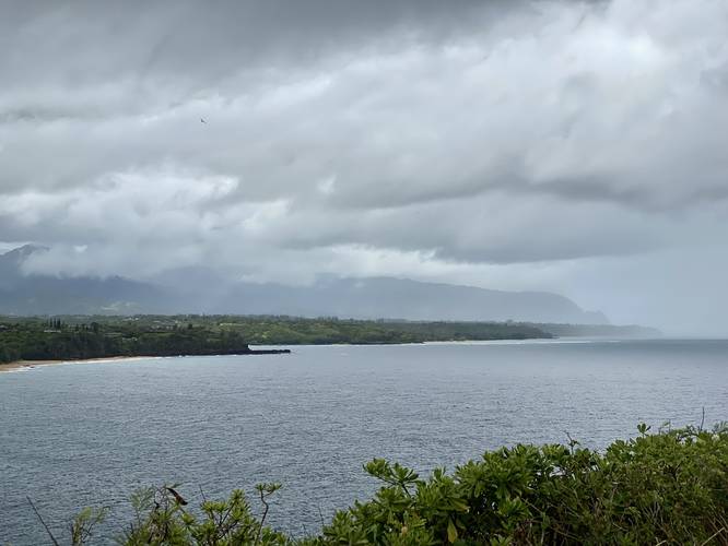 View towards Hanalei Bay and Kauai's northern coast with mountains in the distance