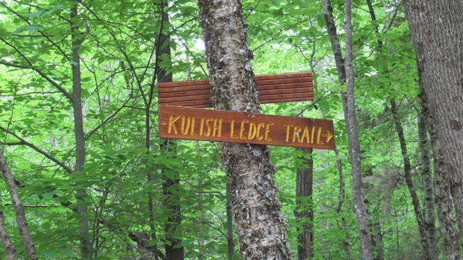 Wooden signs mark the trail