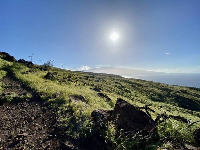 View of the wind turbines, Haleakala's western slopes, and south Maui from the Lahaina Pali Trail