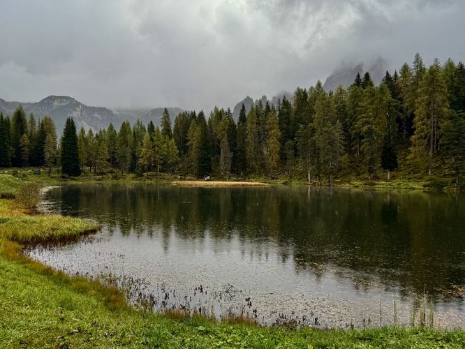 A rainy, moody north-facing view of Lake Antorno in the Dolomites