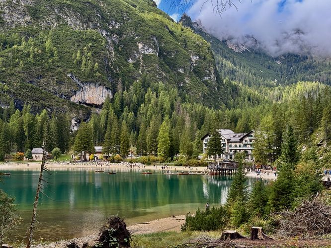 View of Hotel Lago di Braies, the row boat rental dock, and turquoise lake water