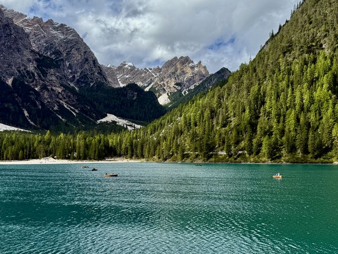 More rowboats in the lake and towering alpine peaks in the background