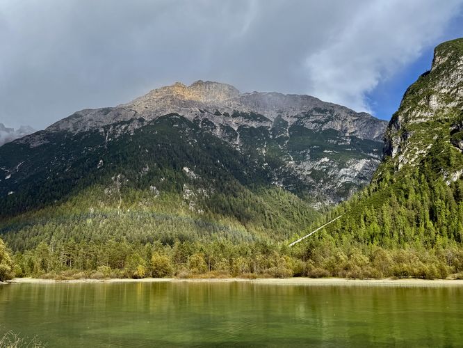 A faint rainbow sits over Lago di Landro