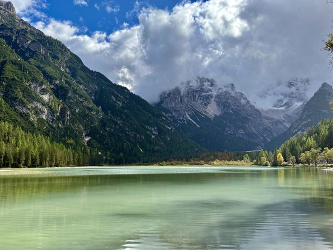Beautiful view of Lago di Lando's turquoise water with the towering alpine mountains of the Monte Cristallo massif