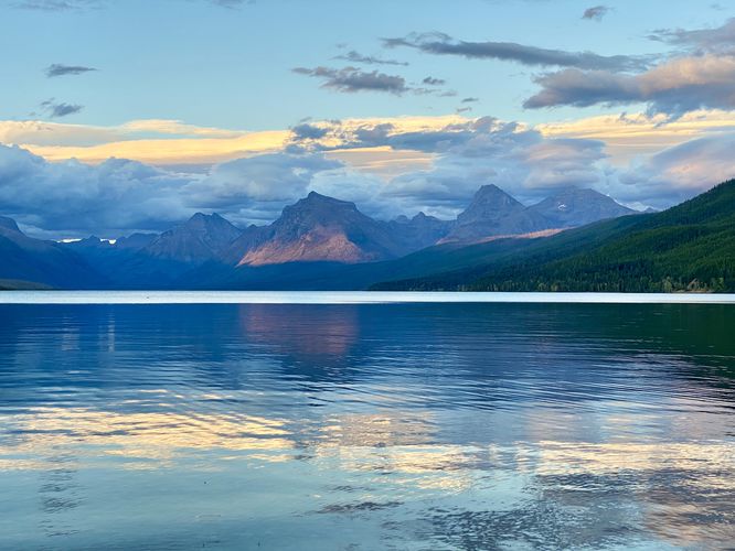Sunset on Lake McDonald and distant alpine mountains