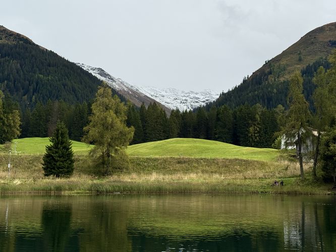 Snow-capped alpine mountains in the distance at Schwarzsee in Davos
