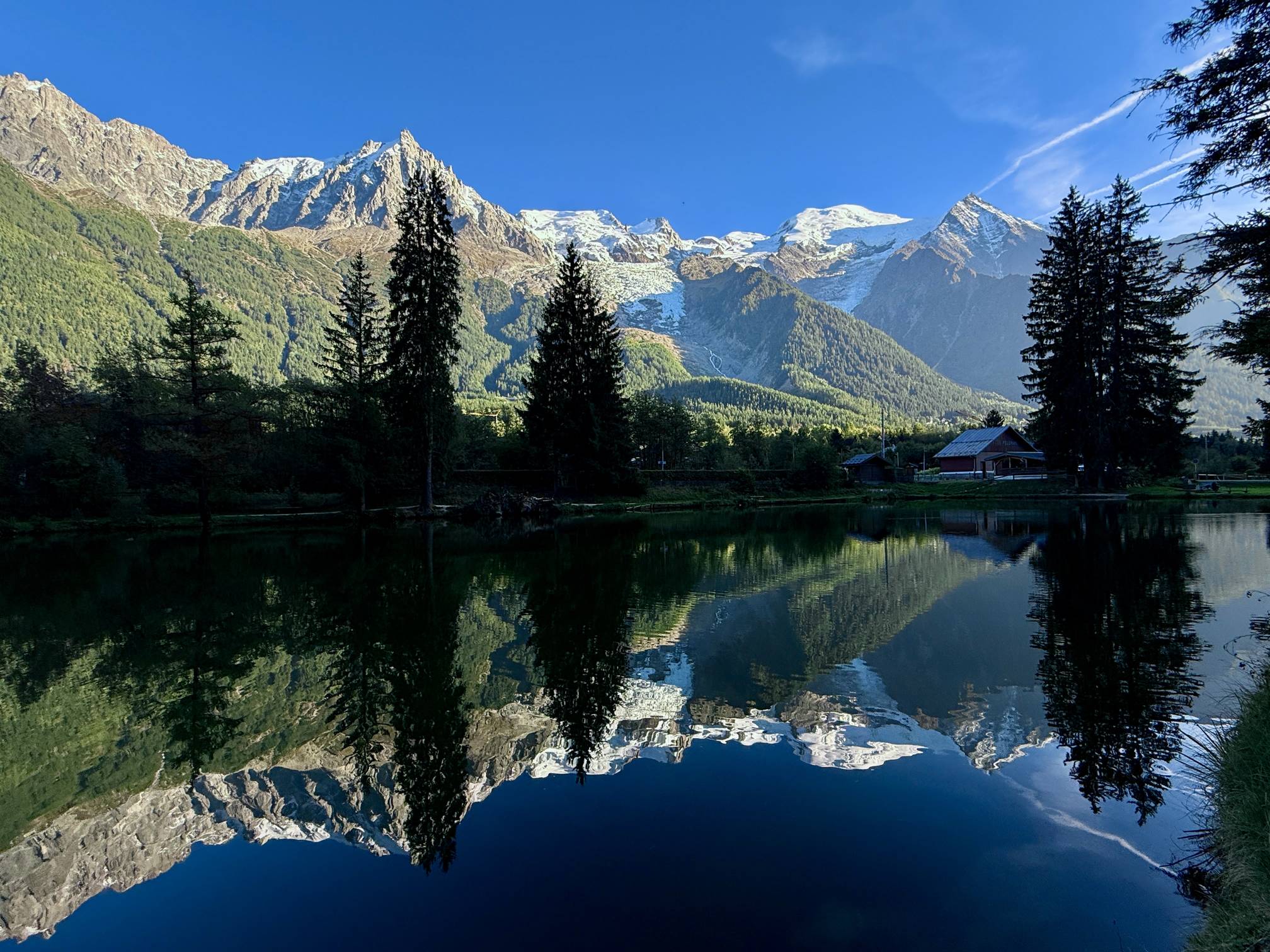 A reflection view of the Mont Blanc massif from a lake in the center of Chamonix, France.