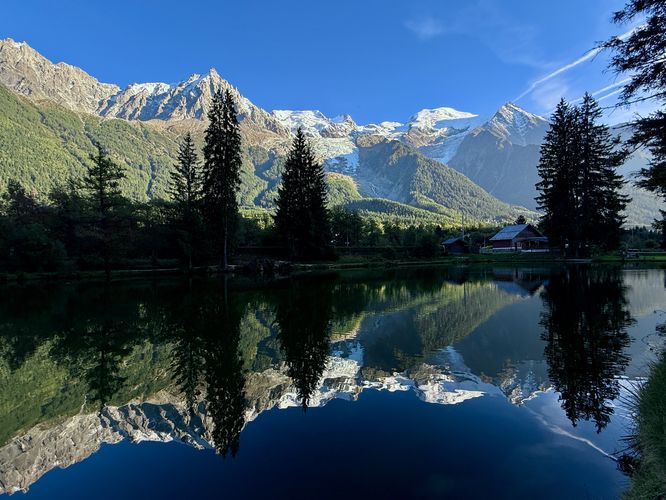 A reflection view of the Mont Blanc massif from a lake in the center of Chamonix, France.