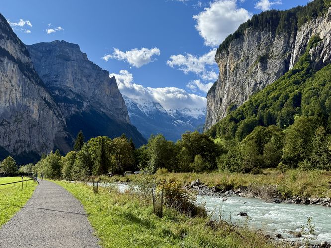 Alpine peaks and massive cliffs tower over the valley
