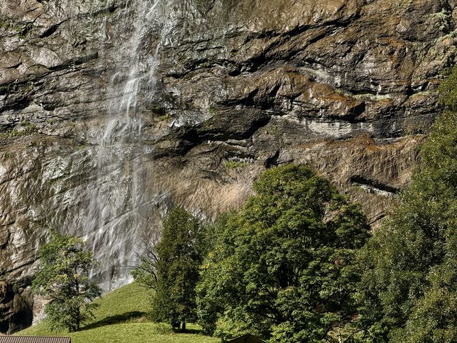 View of Staubbach Falls and visitors in the cliff side trail