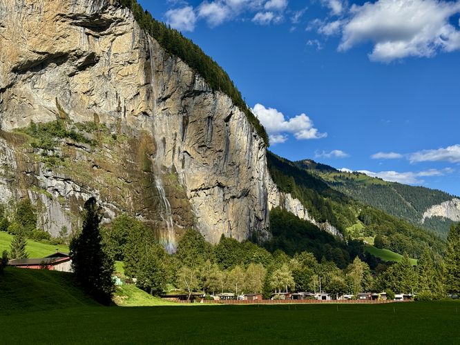 A rainbow appears at the base of Staubbach Falls in Lauterbrunnen