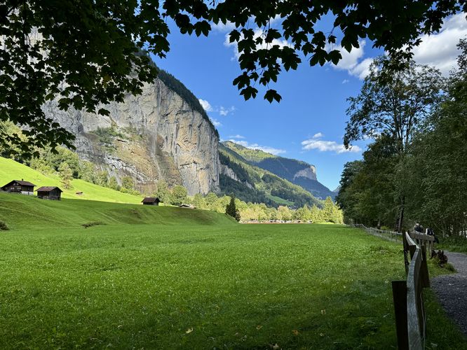 View of the valley and the trail with surrounding cliffs and Staubbach Falls in the distance