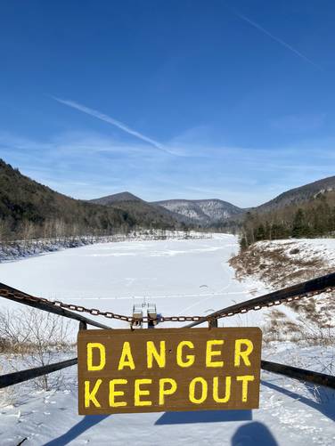 "Danger keep out" reads sign with stairs leading to Little Pine Lake
