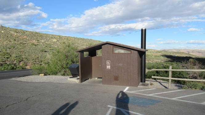 Restroom and trash bin at the trailhead parking area