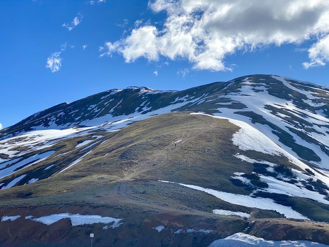Hiker ascends a nearby mountain along the Continental Divide Trail