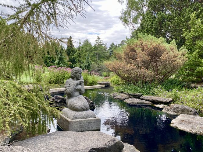 Statue sits adjacent reflection pool