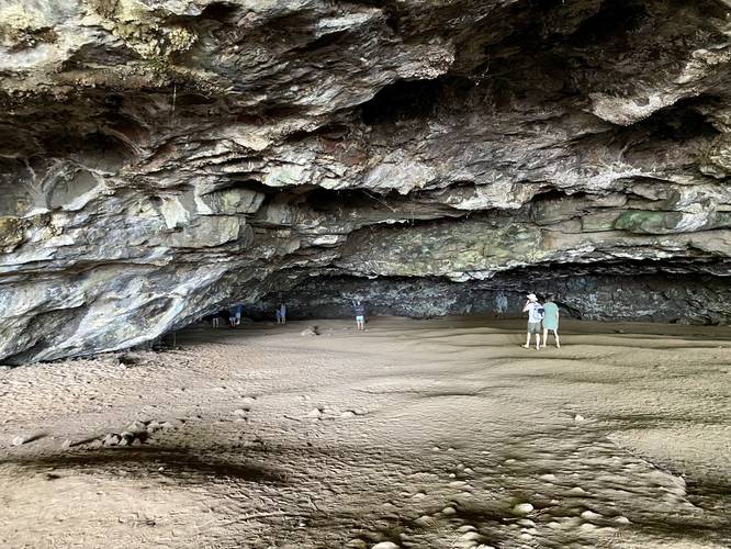 Visitors walk into the depths of the Maniniholo Dry Cave on Kauai