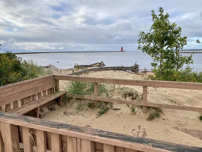 Manistique East Breakwater Lighthouse viewed from trail-side benches