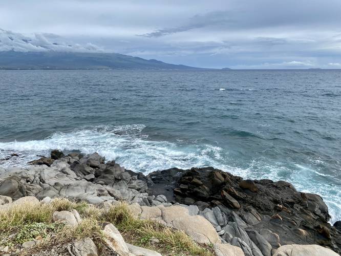 View above the waves at McGregor point (distant view of south Maui and the slopes of Haleakala)
