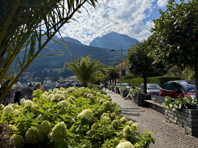 Visitors walk along Lake Como's waterfront in Menaggio