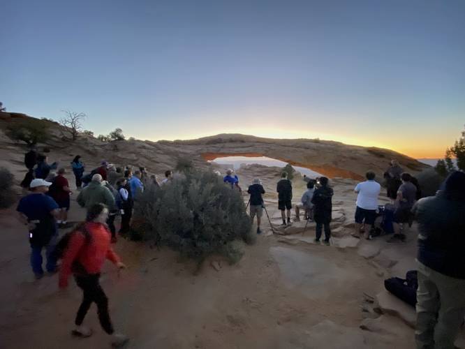 Photographers and hikers at Mesa Arch waiting for sunrise