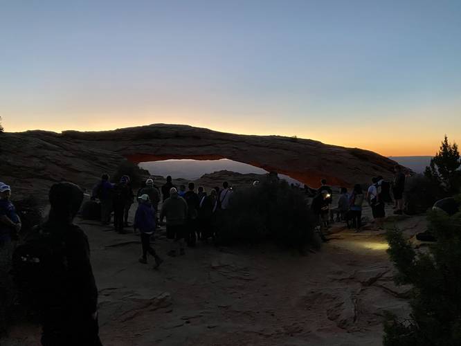 Hordes of people gather at Mesa Arch for sunrise