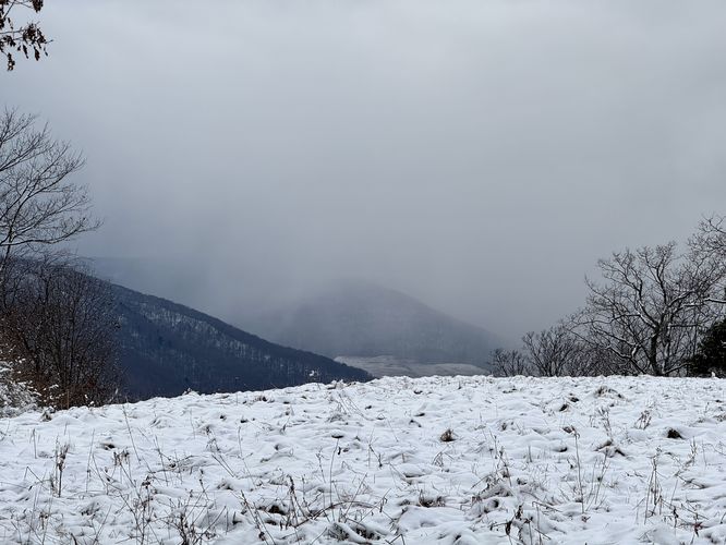 View of distant mountains and a curtain of snow
