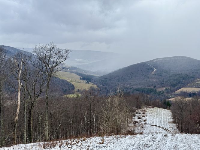 View from the pipeline - a snow curtain covered mountains in the distance