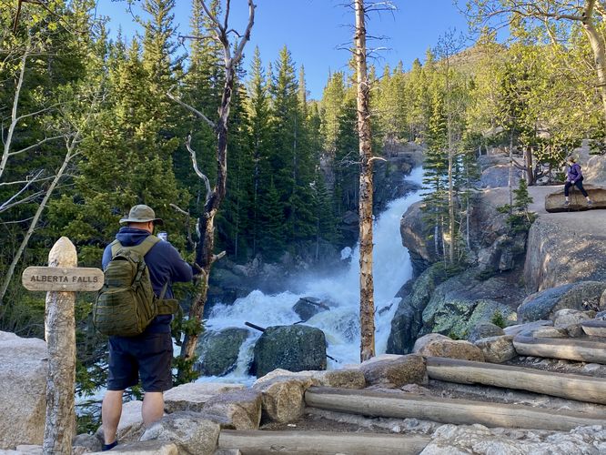 Hiker takes a photo at Alberta Falls