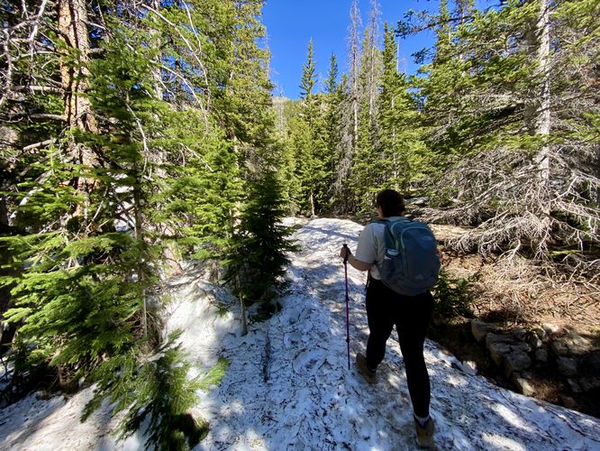 Hiking snowfields along the Sky Pond Trail