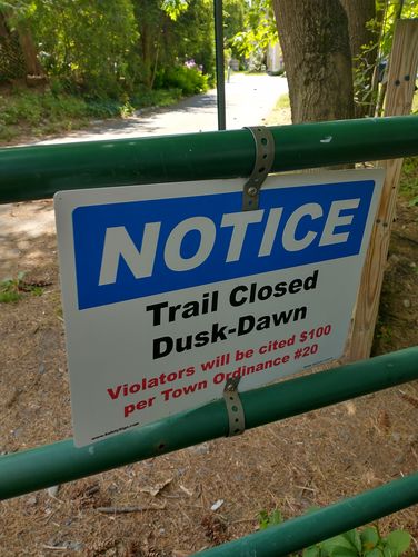 Sign posted on gate at Maple Street Trailhead