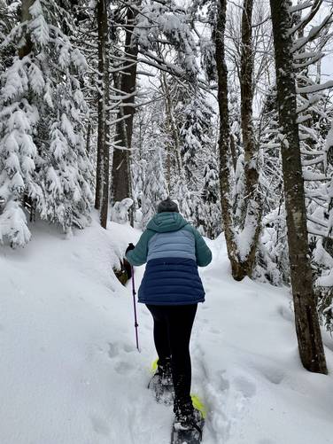 Nina snowshoeing up the Mt. Van Hoevenberg Trail