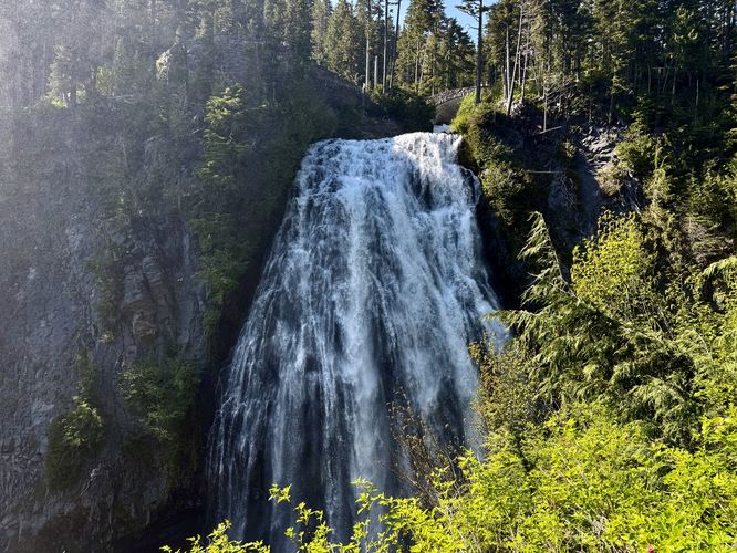View of Narada Falls from the trail with the scenic stone footbridge in the background