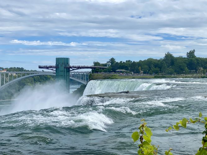 Niagara River spills over feeding American Falls, view from Luna Island