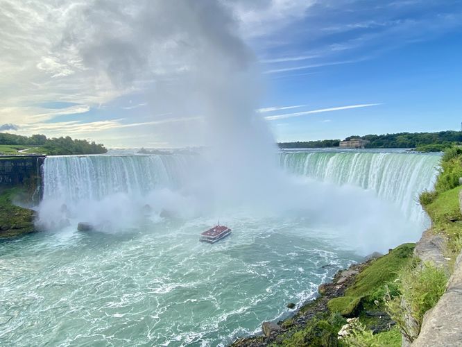 Wide-angle view of a boat at the base of Horseshoe Falls