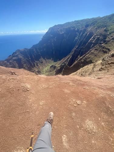 Standing near the edge of the 1,800 vertical cliff drop on the Nu'alolo Trail