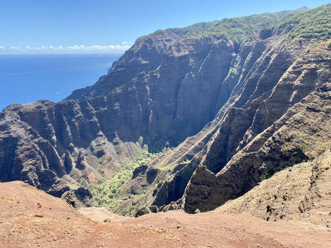 Mountain ridges, 1,800-foot vertical cliffs, and beautiful blue ocean with a mountain valley below - on the Nu'alolo Trail (Kauai)