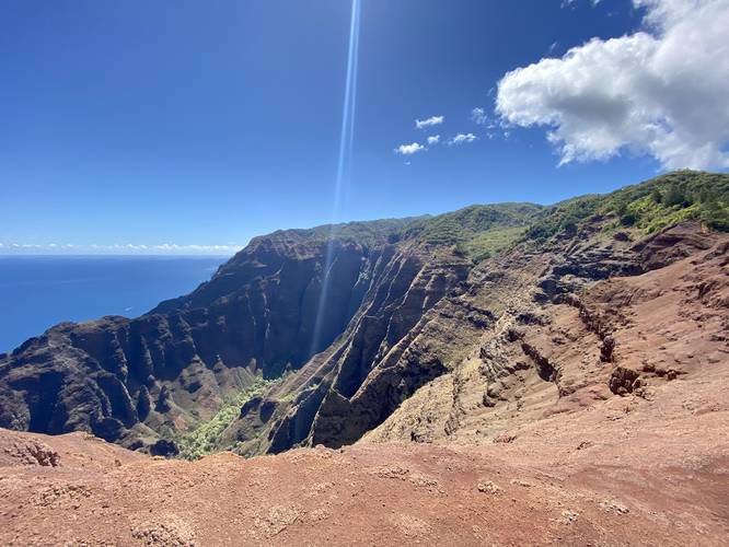 Mountain ridges, 1,800-foot vertical cliffs, and beautiful blue ocean with a mountain valley below - on the Nu'alolo Trail (Kauai) - approaching the Lolo Vista
