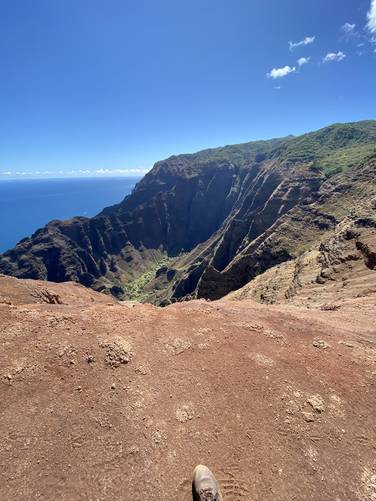 Near the edge of the Nu'alolo Trail (Kauai) on the Na Pali coast peering down into the valley below