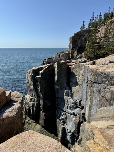 Steep tall cliffs along Maine's coastline at the Otter Cliffs Climbing Rocks