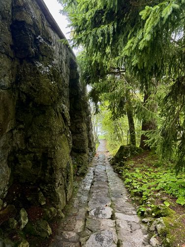 Moss-covered rock walls of the Paxmal and a stone footpath