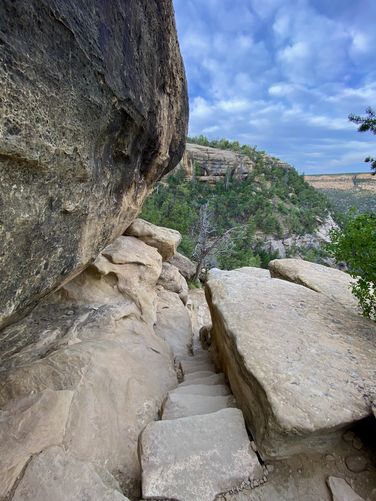 Skinny series of rock stairs leads down the trail