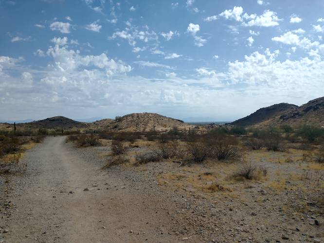 Wide Flat trail with distant Hills