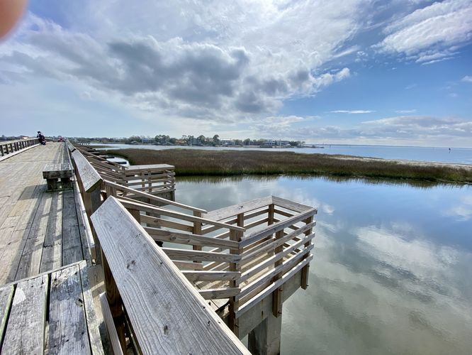 Boardwalk with fishing posts along