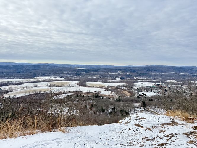 View of Pocumtuck Rock, town of Deerfield below, and the surrounding mountains