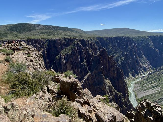View into Black Canyon with hikers on Pulpit Rock