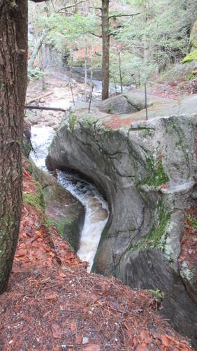Water chiseled rock above the falls