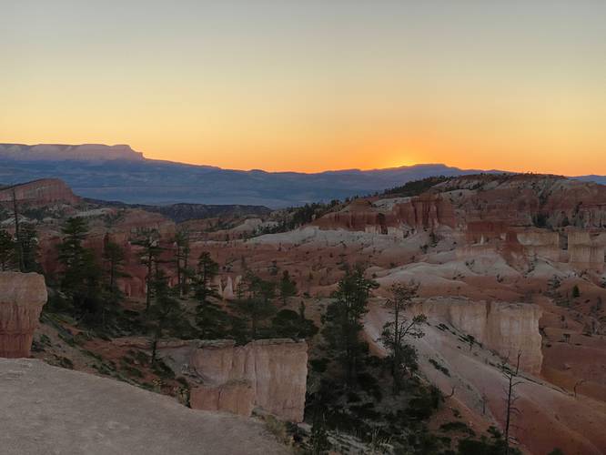 Sunrise colors on the horizon at Bryce Canyon from the Queen's Garden Trail