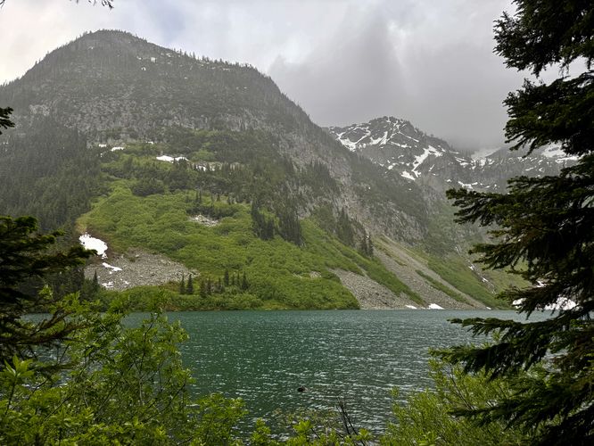 View of alpine peaks towering over Rainy Lake in Washington's North Cascade mountains