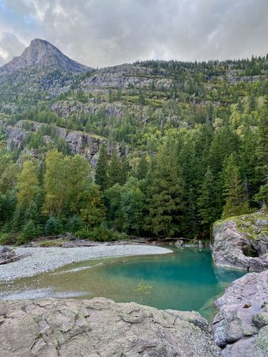 Alpine peak sits above Red Rocks and its turquoise-colored pools